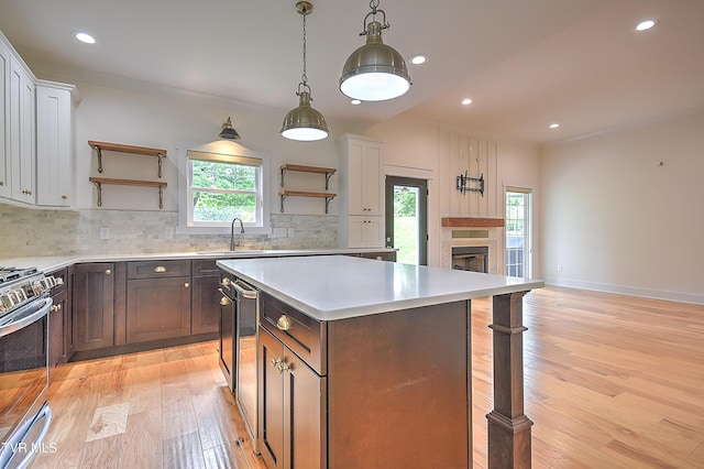 203 Riverwatch Cir, Kingsport, TN 37660 - kitchen with open shelves, a sink, stainless steel stove, light wood-type flooring, and recessed lighting