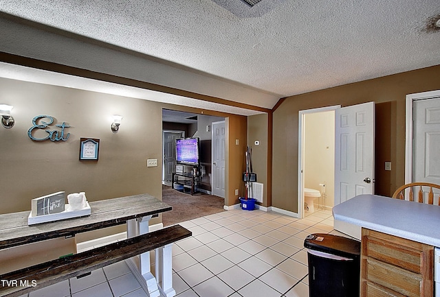 24 Lexington Ct Unit 6, Johnson City, TN 37615 - dining room featuring light carpet, baseboards, light tile patterned floors, and vaulted ceiling