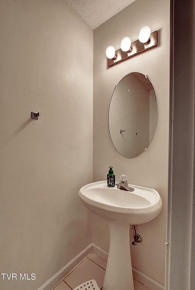24 Lexington Ct Unit 6, Johnson City, TN 37615 - bathroom featuring baseboards, a textured ceiling, and tile patterned floors