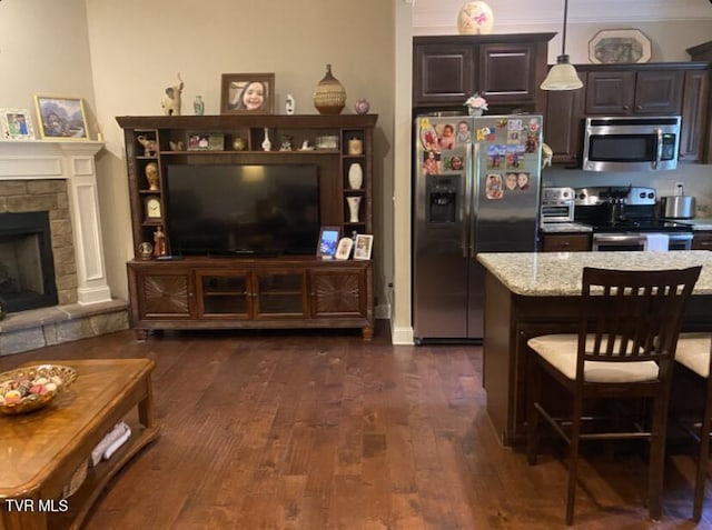 405 Coldwater Dr Unit 405, Johnson City, TN 37601 - kitchen with stainless steel appliances, dark brown cabinets, dark wood-type flooring, a breakfast bar area, and decorative light fixtures