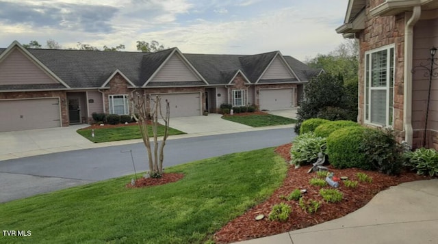 405 Coldwater Dr Unit 405, Johnson City, TN 37601 - view of front facade with driveway, a front yard, an attached garage, and stone siding