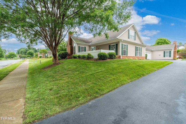 223 Avonlea Pl, Johnson City, TN 37604 - view of front facade featuring a front yard, a chimney, brick siding, asphalt driveway, and an attached garage