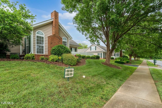 223 Avonlea Pl, Johnson City, TN 37604 - view of home's exterior with a lawn, a chimney, and brick siding