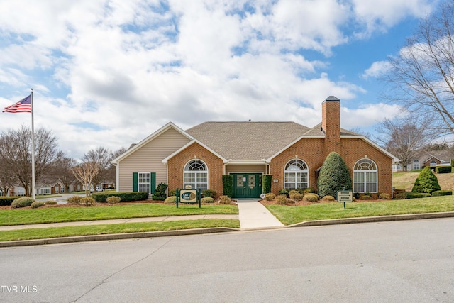 223 Avonlea Pl, Johnson City, TN 37604 - view of front of home featuring brick siding, a front lawn, and a chimney
