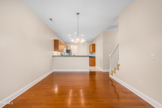 223 Avonlea Pl, Johnson City, TN 37604 - unfurnished living room featuring a chandelier, light wood-style flooring, stairway, and baseboards