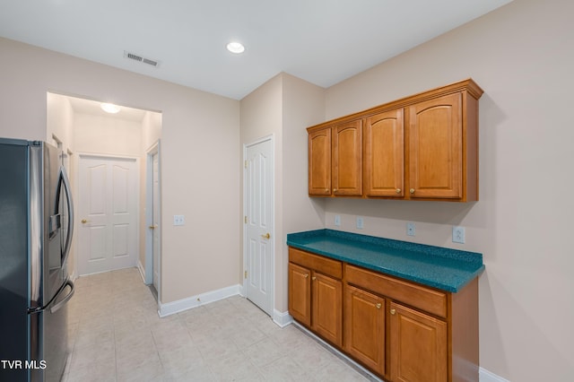 223 Avonlea Pl, Johnson City, TN 37604 - kitchen featuring stainless steel refrigerator with ice dispenser, brown cabinets, baseboards, and light tile patterned floors