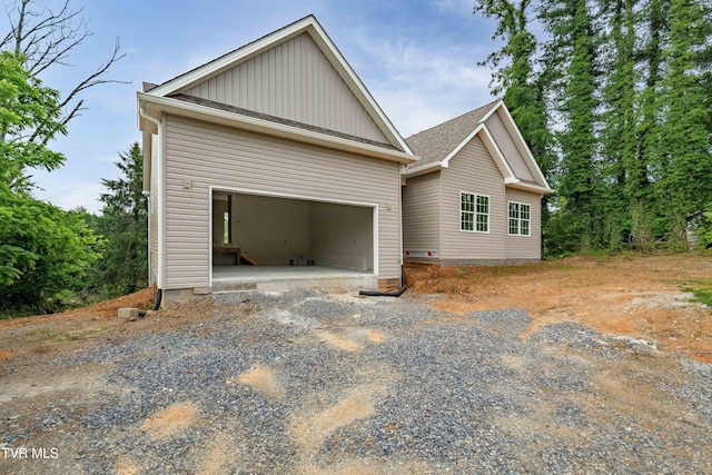 3313 Mckinley Rd, Johnson City, TN 37604 - view of property exterior featuring board and batten siding, gravel driveway, and an attached garage
