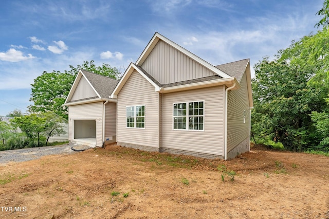 3313 Mckinley Rd, Johnson City, TN 37604 - view of front of property featuring board and batten siding, driveway, roof with shingles, and a garage