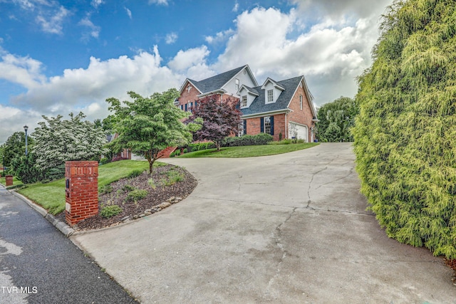 5621 John Gaines Blvd, Kingsport, TN 37664 - view of front of home with curved driveway, brick siding, a front lawn, and a garage