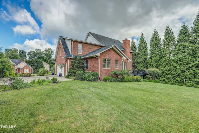 5621 John Gaines Blvd, Kingsport, TN 37664 - view of side of home featuring brick siding, a chimney, a lawn, concrete driveway, and a garage