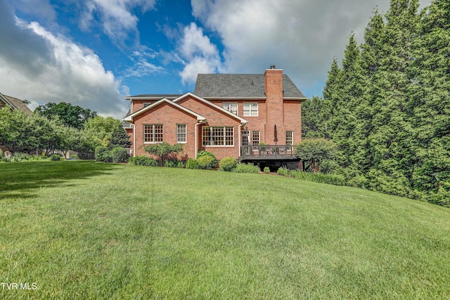 5621 John Gaines Blvd, Kingsport, TN 37664 - rear view of house with a chimney, brick siding, a lawn, and a deck