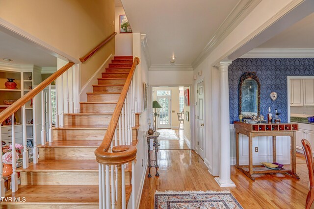 5621 John Gaines Blvd, Kingsport, TN 37664 - stairs with wood finished floors, ornamental molding, ornate columns, and wallpapered walls