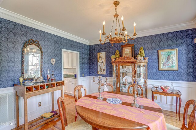 5621 John Gaines Blvd, Kingsport, TN 37664 - dining space featuring a chandelier, ornamental molding, wallpapered walls, a wainscoted wall, and light wood-style flooring