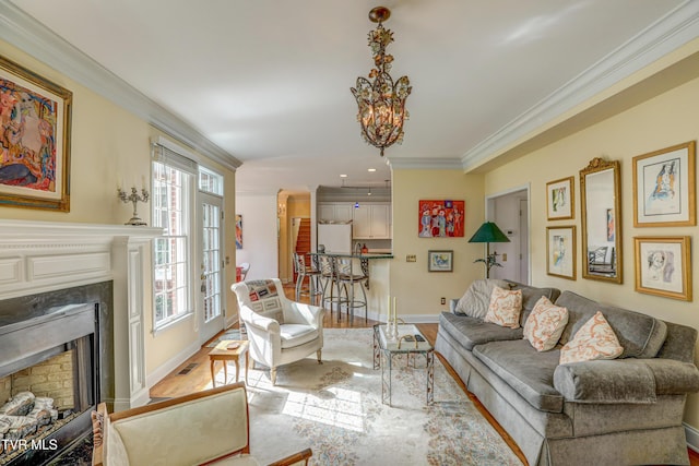 5621 John Gaines Blvd, Kingsport, TN 37664 - living room featuring a premium fireplace, crown molding, wood finished floors, baseboards, and a chandelier