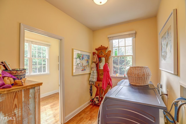 5621 John Gaines Blvd, Kingsport, TN 37664 - laundry area with washer and clothes dryer, healthy amount of natural light, light wood-style floors, and baseboards