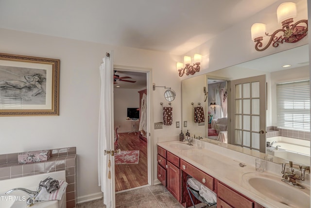 5621 John Gaines Blvd, Kingsport, TN 37664 - ensuite bathroom with double vanity, a bath, ceiling fan, and tile patterned floors