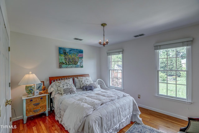 5621 John Gaines Blvd, Kingsport, TN 37664 - bedroom with baseboards, wood finished floors, and a chandelier