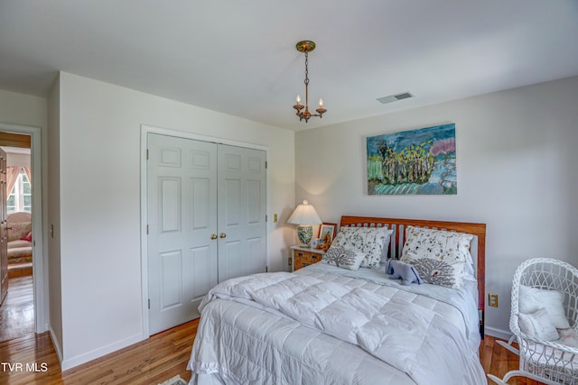 5621 John Gaines Blvd, Kingsport, TN 37664 - bedroom with a chandelier, wood finished floors, a closet, and baseboards