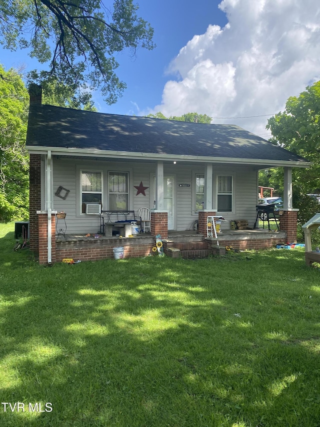 4228 Sullivan Gardens Dr, Kingsport, TN 37660 - view of front of house featuring covered porch, a front lawn, and a shingled roof