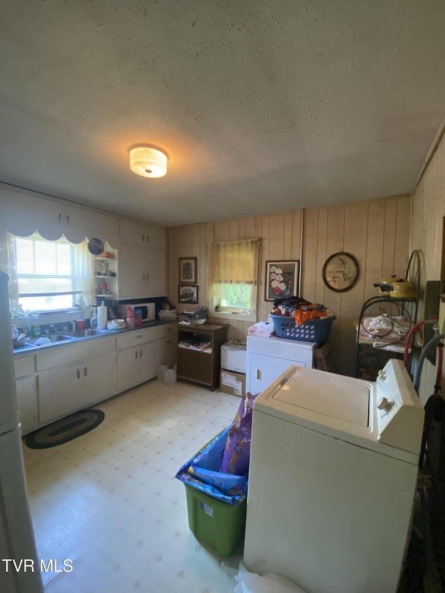 4228 Sullivan Gardens Dr, Kingsport, TN 37660 - washroom with a textured ceiling, washer and clothes dryer, and wood walls