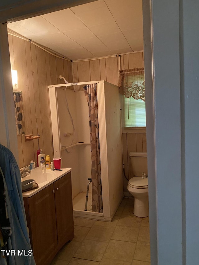 4228 Sullivan Gardens Dr, Kingsport, TN 37660 - bathroom featuring a shower stall, vanity, wood walls, and tile patterned floors