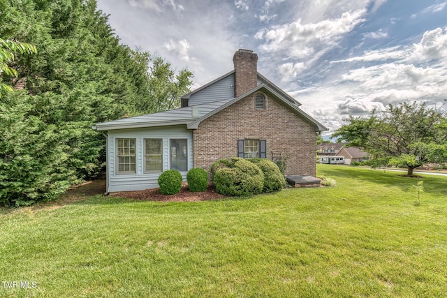 3510 Bondwood Cir, Johnson City, TN 37604 - view of home's exterior with a chimney, brick siding, and a yard