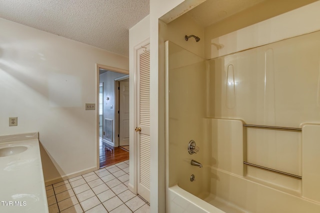 3510 Bondwood Cir, Johnson City, TN 37604 - bathroom with shower / bathtub combination, tile patterned floors, a textured ceiling, double vanity, and baseboards