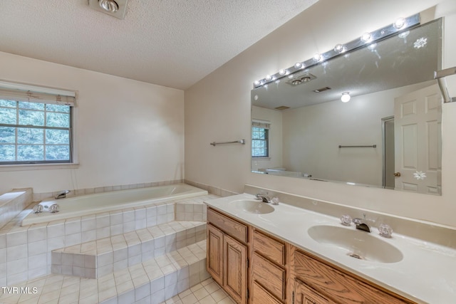 3510 Bondwood Cir, Johnson City, TN 37604 - full bathroom with a bath, double vanity, healthy amount of natural light, a textured ceiling, and tile patterned floors