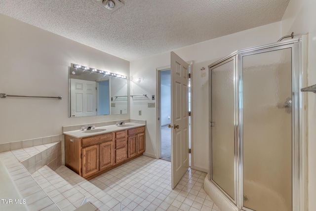 3510 Bondwood Cir, Johnson City, TN 37604 - full bath with a shower stall, a textured ceiling, double vanity, and tile patterned flooring