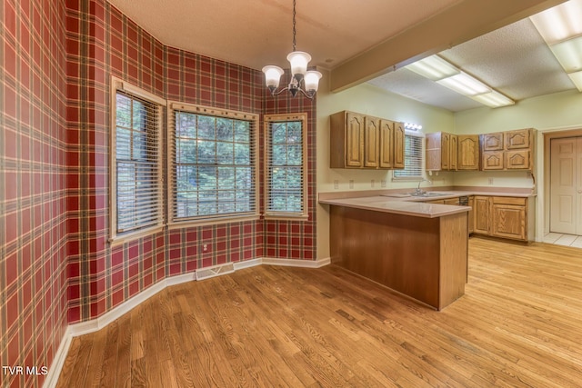 3510 Bondwood Cir, Johnson City, TN 37604 - kitchen with wallpapered walls, light wood-style floors, light countertops, and a chandelier