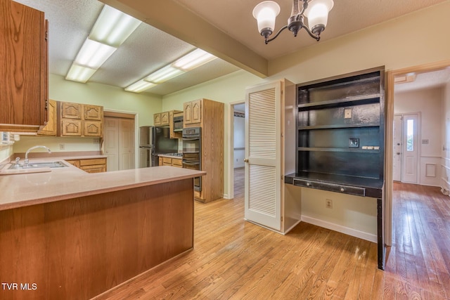 3510 Bondwood Cir, Johnson City, TN 37604 - kitchen featuring freestanding refrigerator, a chandelier, a sink, light wood-type flooring, and light countertops