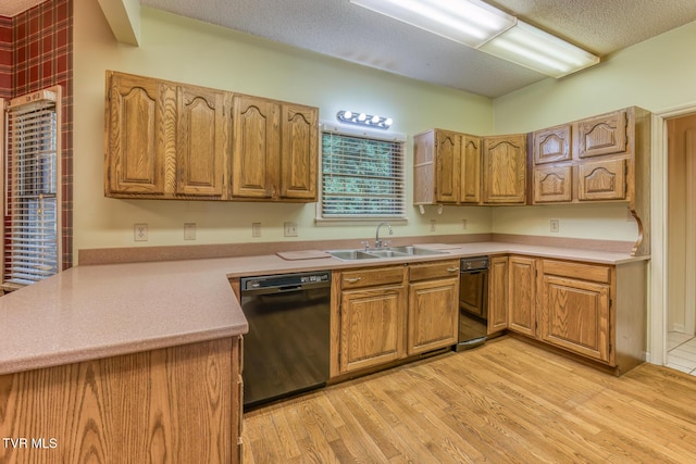 3510 Bondwood Cir, Johnson City, TN 37604 - kitchen featuring dishwasher, a sink, a peninsula, light wood-style flooring, and a textured ceiling