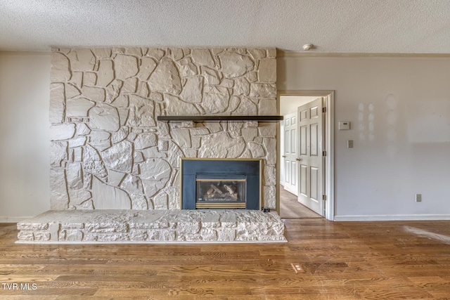 3510 Bondwood Cir, Johnson City, TN 37604 - detailed view of a textured ceiling, a fireplace, wood finished floors, and baseboards