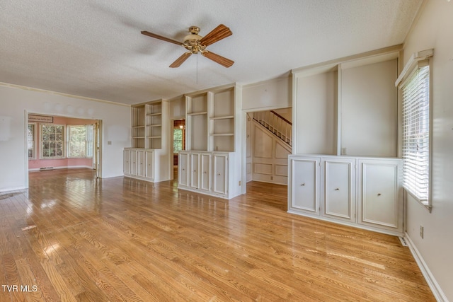 3510 Bondwood Cir, Johnson City, TN 37604 - unfurnished room featuring ceiling fan, a textured ceiling, light wood-style floors, and stairway