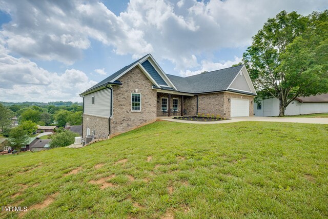 1 Sweetwood Dr, Johnson City, TN 37615 - view of front of house with concrete driveway, brick siding, a front lawn, and a garage
