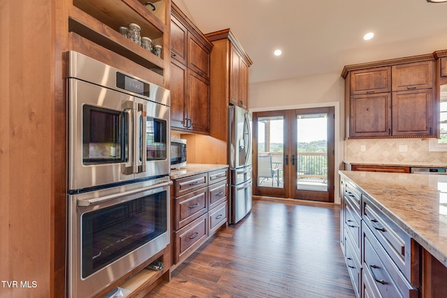 1 Sweetwood Dr, Johnson City, TN 37615 - kitchen featuring french doors, appliances with stainless steel finishes, light stone countertops, decorative backsplash, and dark wood-style floors