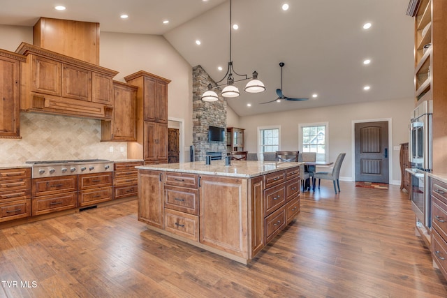 1 Sweetwood Dr, Johnson City, TN 37615 - kitchen featuring high vaulted ceiling, appliances with stainless steel finishes, a ceiling fan, brown cabinetry, and dark wood finished floors