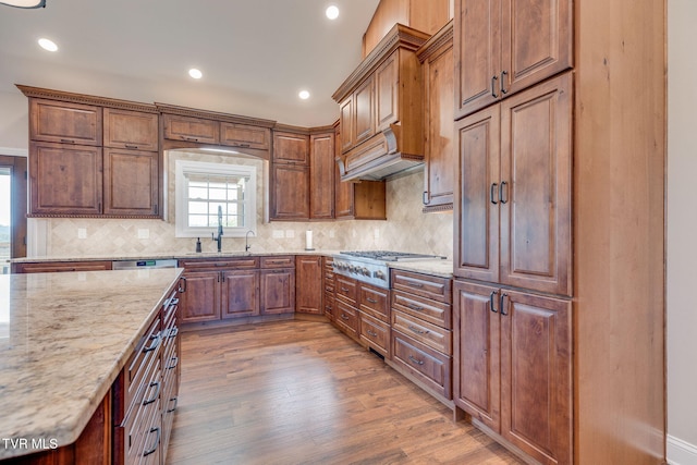 1 Sweetwood Dr, Johnson City, TN 37615 - kitchen featuring stainless steel gas stovetop, decorative backsplash, light stone counters, light wood-style flooring, and a sink