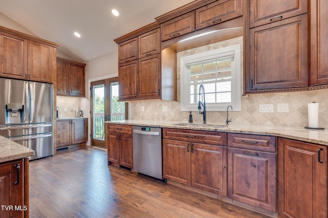 1 Sweetwood Dr, Johnson City, TN 37615 - kitchen featuring appliances with stainless steel finishes, a sink, lofted ceiling, dark wood-style floors, and light stone countertops
