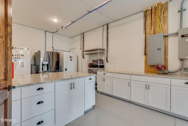 1 Sweetwood Dr, Johnson City, TN 37615 - kitchen with electric panel, stainless steel fridge with ice dispenser, white cabinetry, concrete flooring, and light stone counters