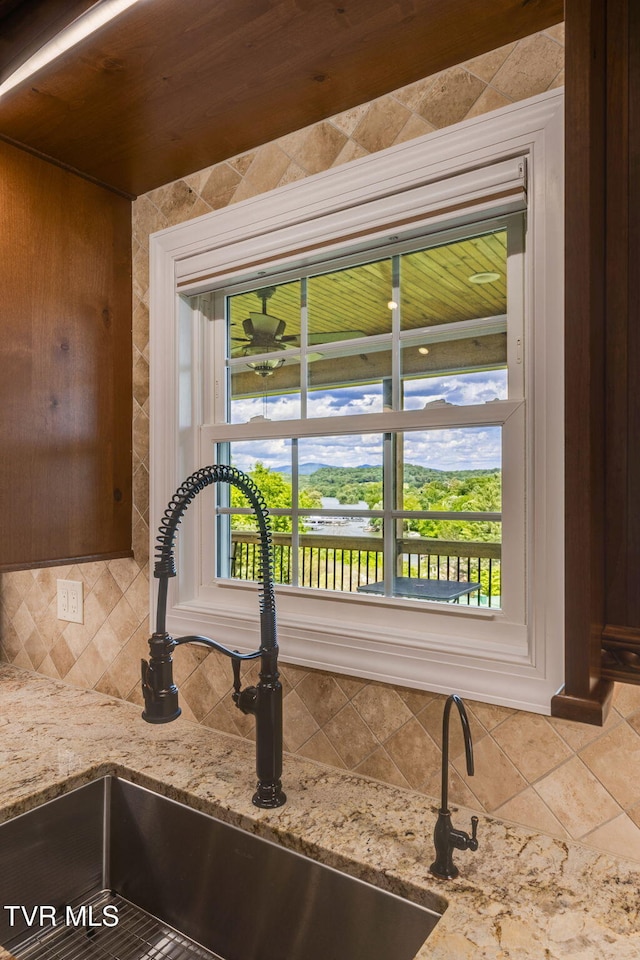 1 Sweetwood Dr, Johnson City, TN 37615 - kitchen view of decorative backsplash, a sink, and light stone countertops