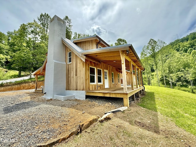 538 Punkton Rd, Del Rio, TN 37727 - back of house featuring a chimney, board and batten siding, and a lawn