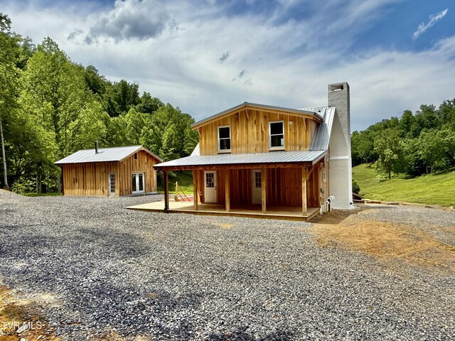 538 Punkton Rd, Del Rio, TN 37727 - view of front of home with a chimney, covered porch, metal roof, and board and batten siding