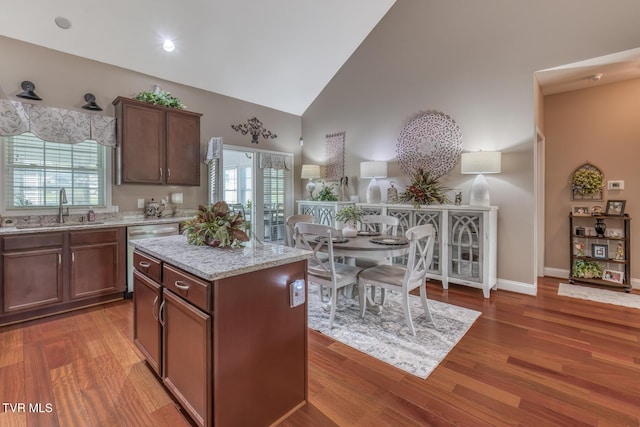 171 Brighton Pl, Bristol, TN 37620 - kitchen featuring a sink, dishwasher, high vaulted ceiling, light stone countertops, and wood finished floors