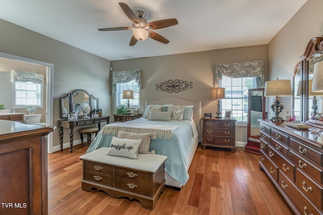 171 Brighton Pl, Bristol, TN 37620 - bedroom with light wood finished floors, multiple windows, baseboards, and a ceiling fan