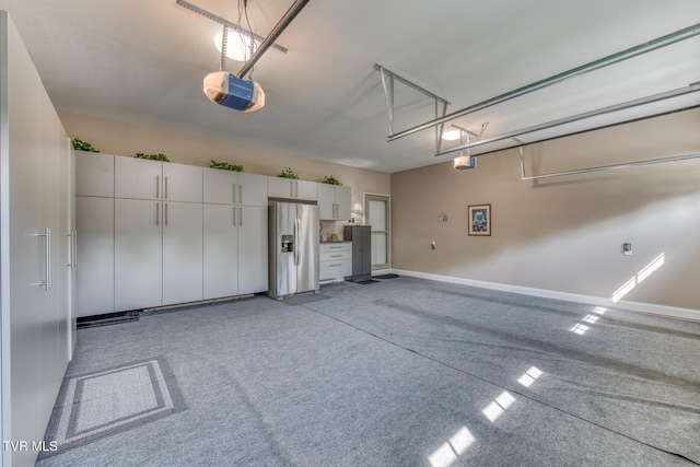 171 Brighton Pl, Bristol, TN 37620 - garage with stainless steel fridge with ice dispenser, a garage door opener, and baseboards