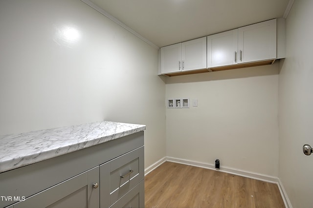 2221 Elizabethton Hwy, Johnson City, TN 37601 - washroom with cabinet space, light wood-type flooring, baseboards, washer hookup, and crown molding