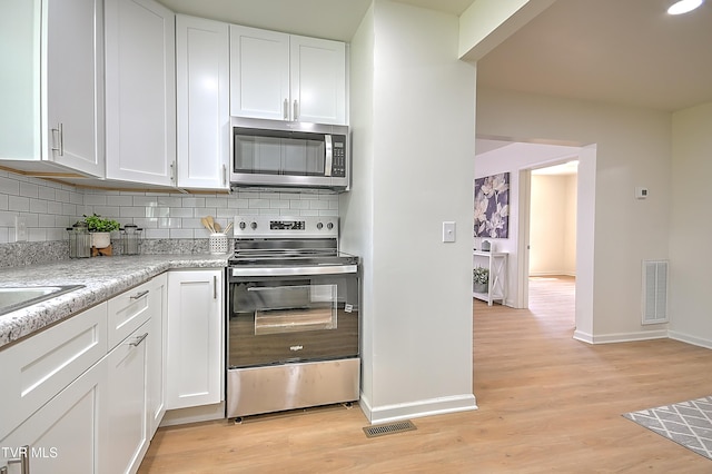 2221 Elizabethton Hwy, Johnson City, TN 37601 - kitchen with stainless steel appliances, baseboards, and white cabinets