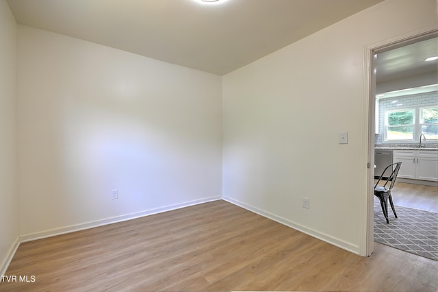 2221 Elizabethton Hwy, Johnson City, TN 37601 - unfurnished room featuring light wood-style flooring, a sink, and baseboards