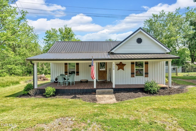 120 Stine St, Bristol, TN 37620 - view of front of house with metal roof, a front yard, a porch, and board and batten siding